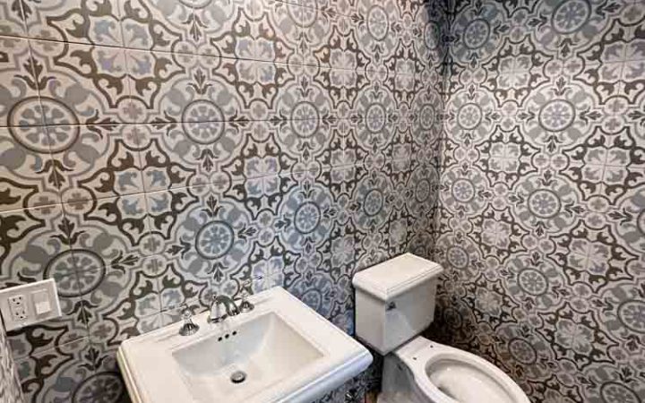 Powder Room Remodeled with patterned porcelain tiles for wall