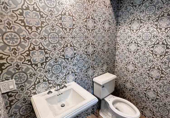 Powder Room Remodeled with patterned porcelain tiles for wall
